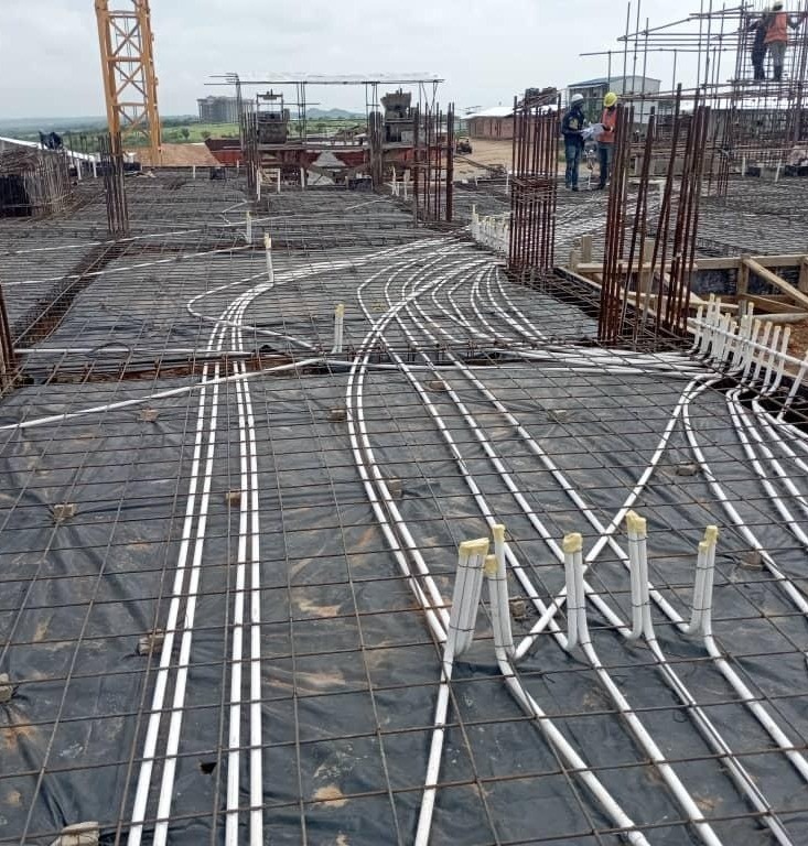 Aerial view of FlowTech electrical conduit routing across slab reinforcement on a Zanzibar construction site